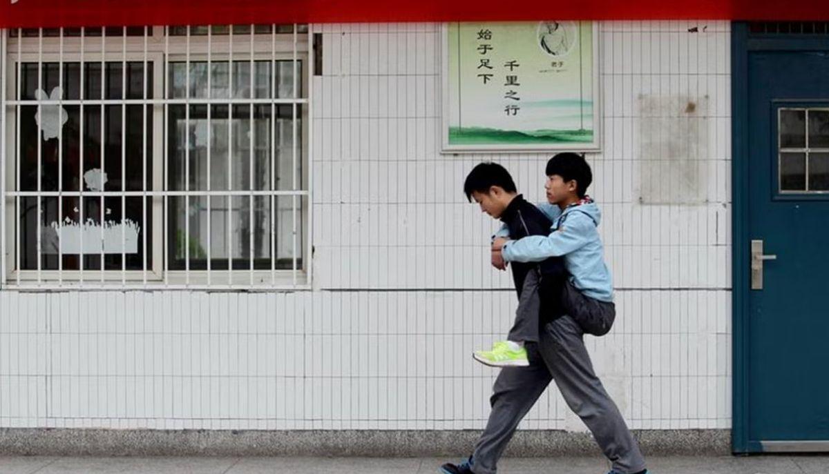 Non può camminare, l'amico lo porta a scuola per 3 anni sulle spalle